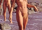 Retro couple in vintage photo at a rocky beach furry and completely naked