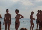 Couple of cute topless girls expose their beauty on sea shore