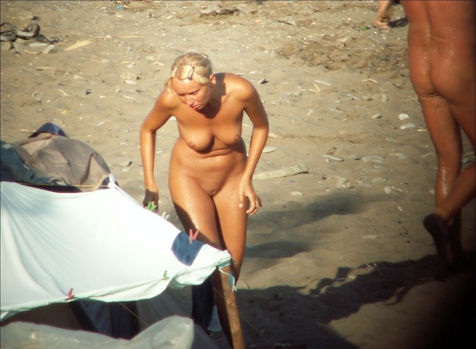 Nude girl exposed by voyeurs walking on the beach