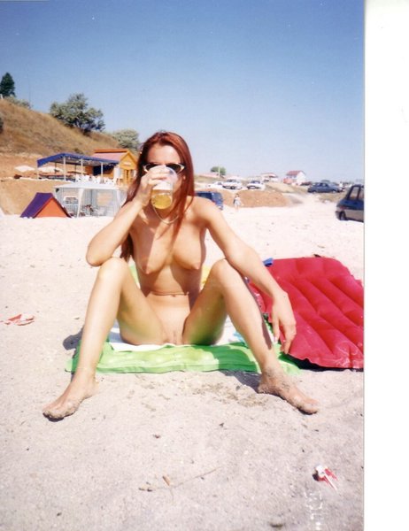 Nudist beach with horny young naked girls drinking a cold tasteful beer
