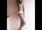Skinny shy teen wears just a yellow undies and expose her tiny topless titties