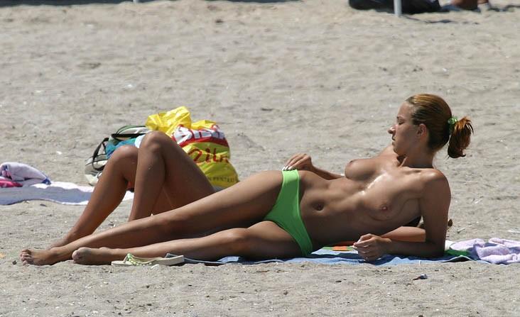 Hot teen caught topless on the beach near her best friend