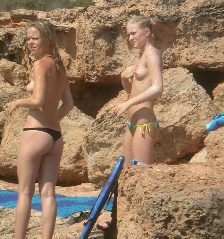 Topless amazing russian chicks at the rocky beach in tight pretty bikini
