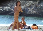 Open minded tourists setup a nudist camp near the shore