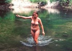 Naked teen cools down by frolicking at the shallow part of the lake