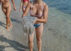 Nature loving babe tries to save the jellyfish with naked tourists on the background