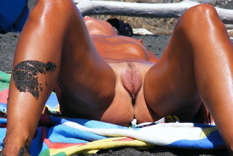 Sun baked nudist gives everyone a peak of her juicy pussy