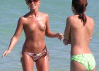 Topless chicks play around the water to get a toned body
