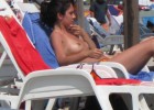Topless babe wondering if someone is watching her