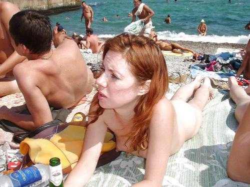 Redhead tanning on a nudist beach
