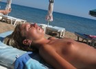 Tanning blond beauty exposed topless