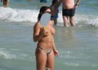 Perky titted topless woman in ocean